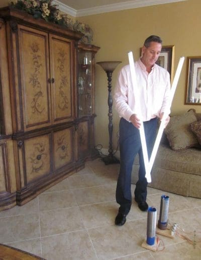 Tom Paladino holds lightbulbs in close proximity to the Scalar Energy instruments
