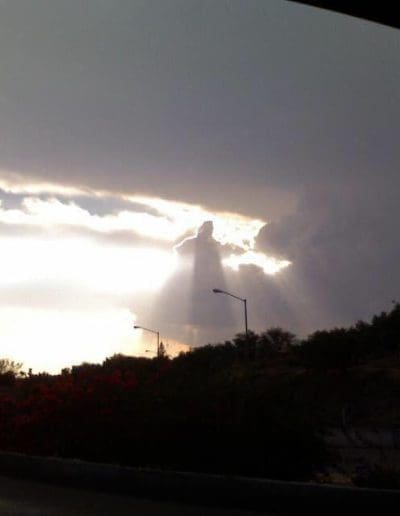 Jesus appears in the clouds clothed in radiant, scalar light.